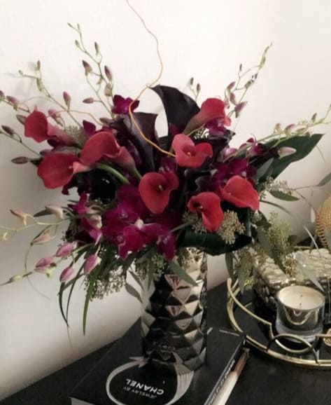 Imperial Bouquet - Burgundy and black mini calla lilies, dendrobium orchids and tropical leaves.