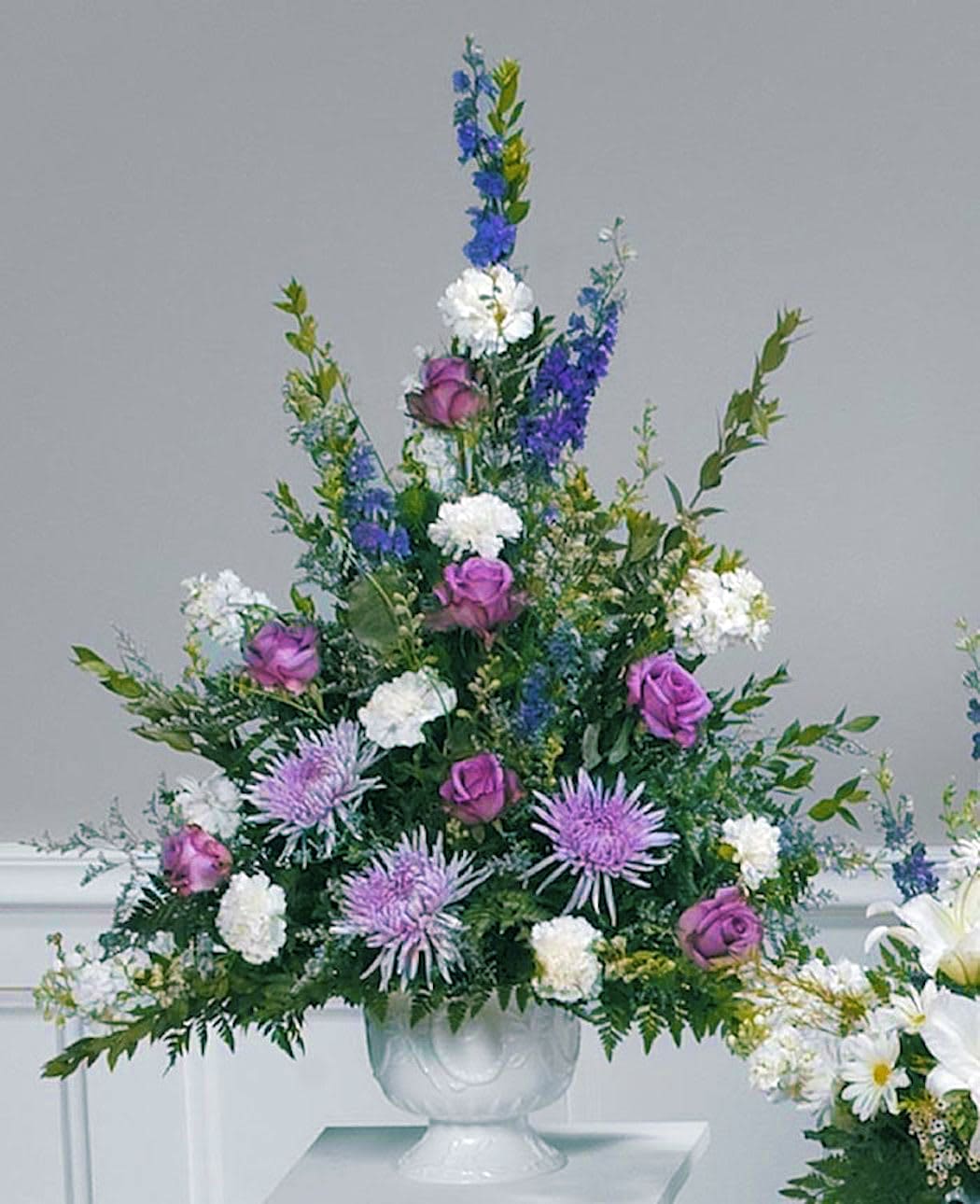 Lovely Lavender Pedestal Arrangement - Lovely lavender roses and spider mums with purple larkspur and white carnations create a beautiful peace appropriate for anyone. 