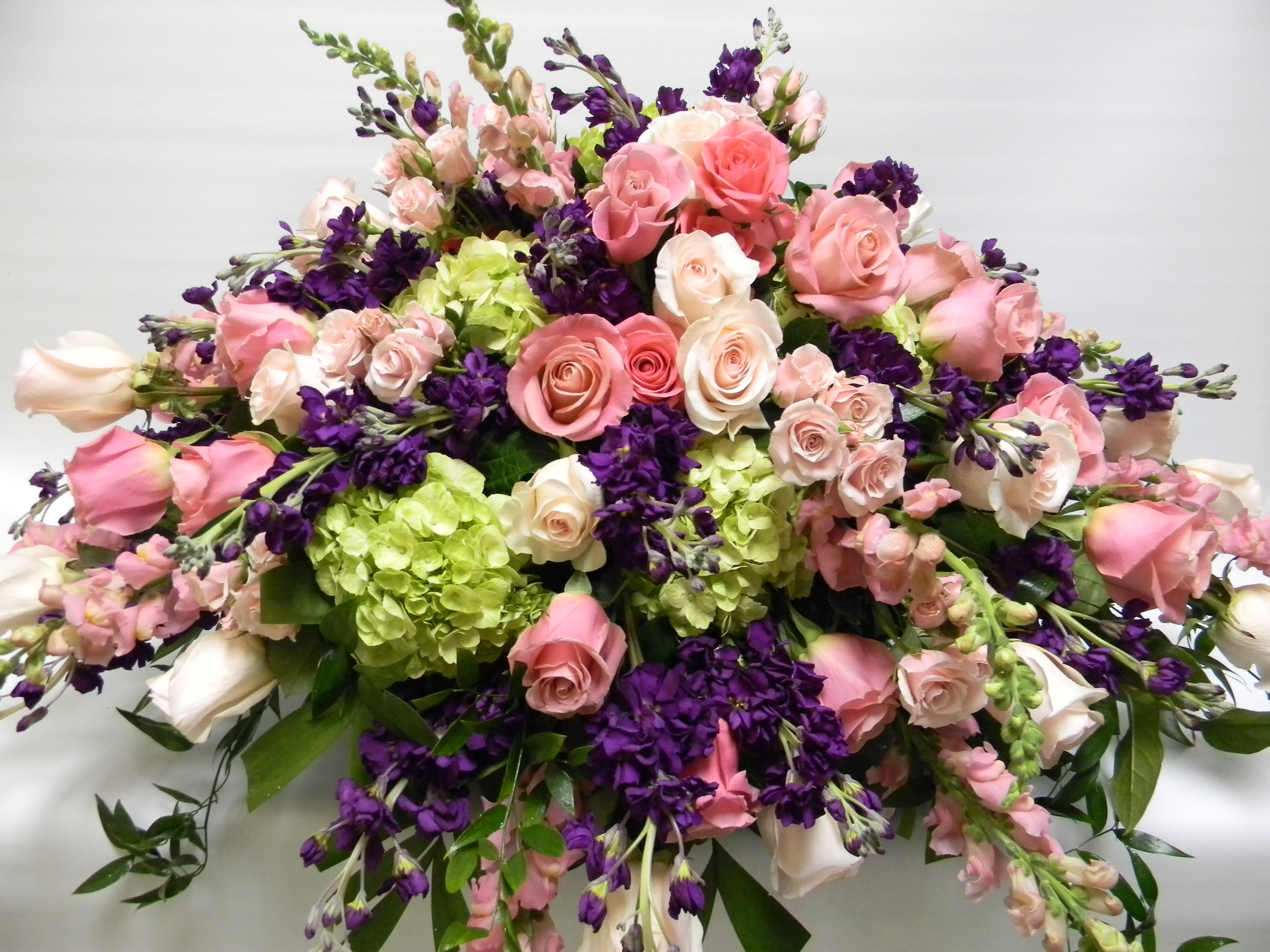 Beautiful tribute in pnk Beautiful tribute in pnk - Casket spray of Pink roses, snap dragons with lime green hydrangea and purple and lavender stock