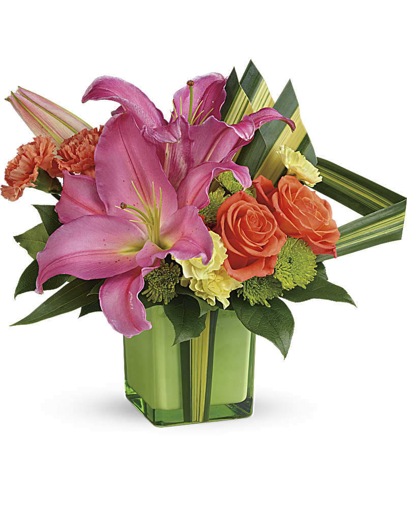 Teleflora's Color Me Cute Bouquet - Cute, colorful and carefully curated, this artistic arrangement of hot pink lilies, orange roses and dramatic hala leaves is a tropically-inspired treat they'll adore! Orange roses, hot pink oriental lilies, orange carnations, miniature yellow carnations, and green cushion spray chrysanthemums are accented with hala leaf and lemon leaf. Delivered in a Leaf Color Splash cube.