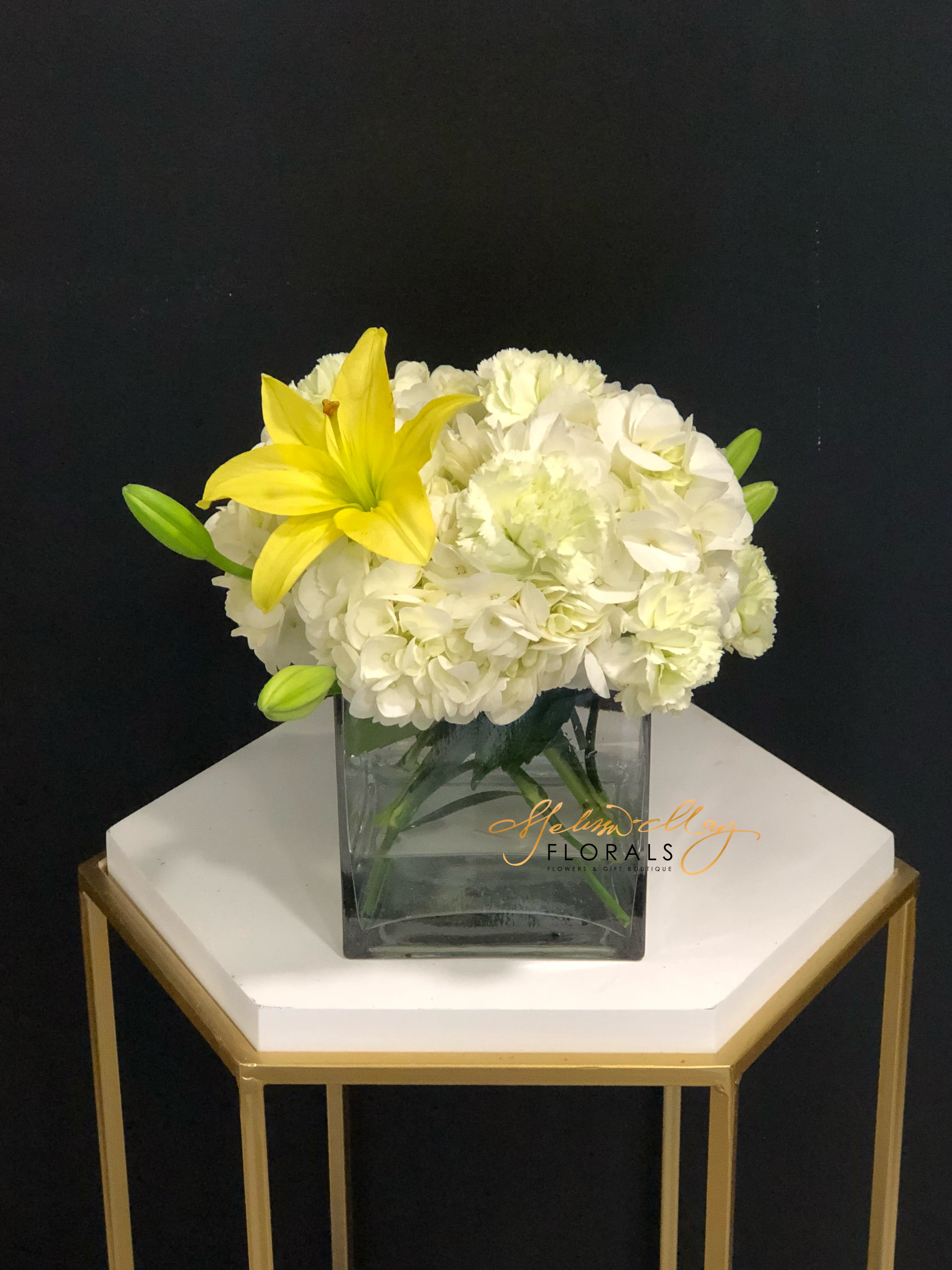 Kiss of the Sunshine  - Bring the sunshine to someone's day with the gorgeous, fragrant arrangement. This arrangement contains asiatic lilies, spray roses or carnations and hydrangea. It is the perfect gift for someone's birthday or to uplift someone's spirits. APPROXIMATE DIMENSIONS: 9&quot;L X 9&quot;W x 9&quot;H