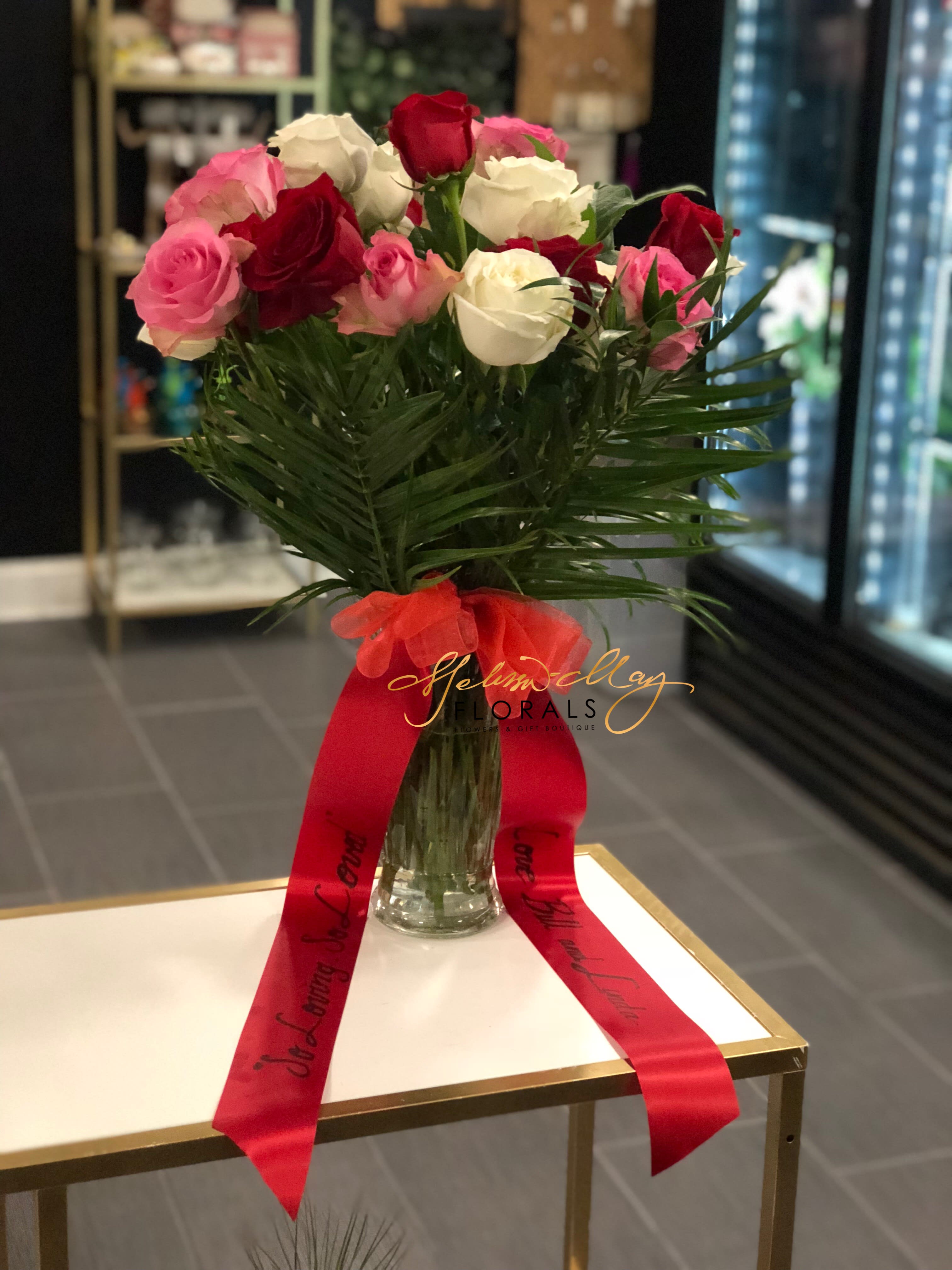 Dearly Missed Arrangement - At times you may want to tell someone that you miss them dearly but the words are not coming right out. This beautiful assortment of red, white, and pink roses with greenery with do that for you. Just order it today to give to that special someone. 