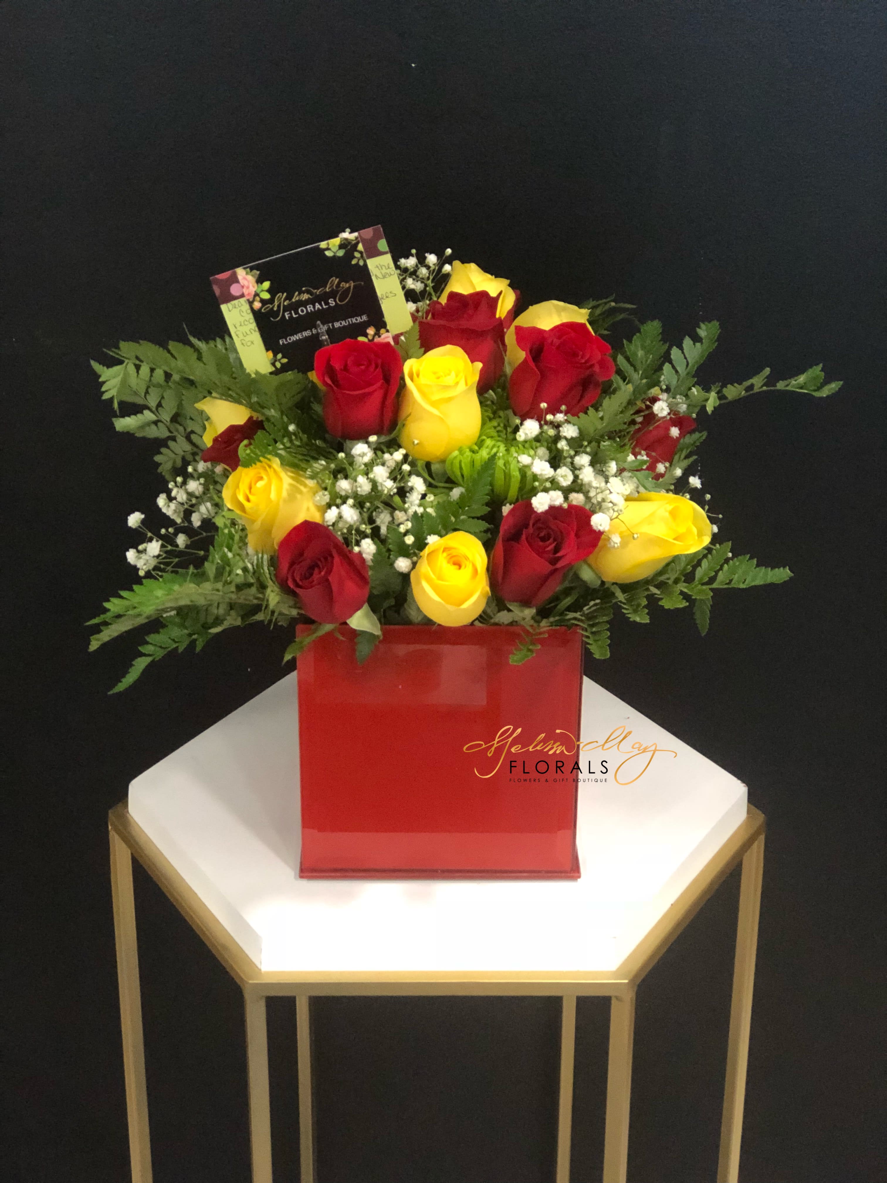 Sweetheart Rose Arrangement  - This beautiful assortment of fresh flowers includes varieties such as red roses, yellow roses and assorted accent flowers. These flowers arrived arranged in a beautiful red cube container that is a great arrangement for sweethearts of all ages!
