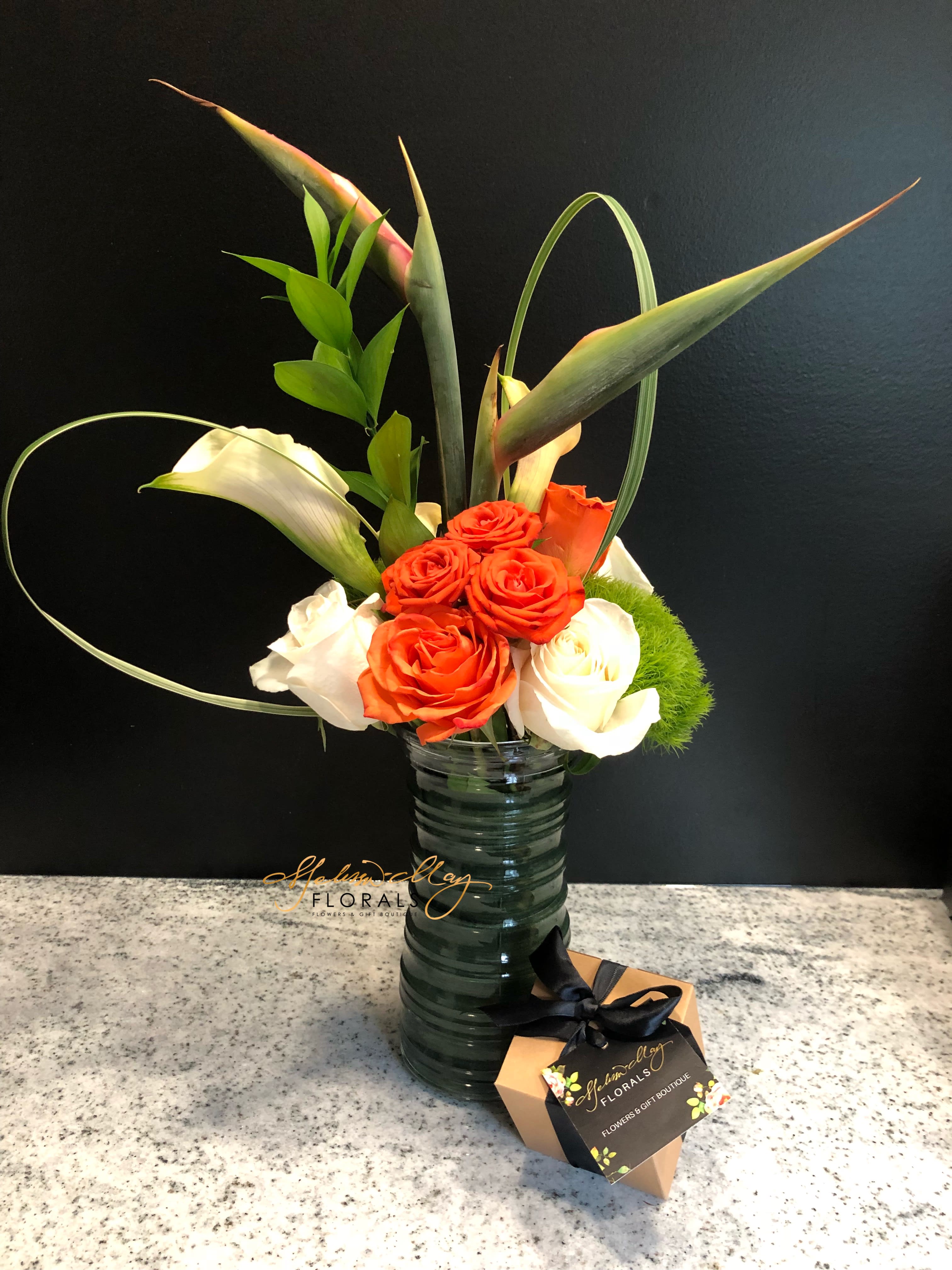 Paradise Island - The vibrant colors in this exotic arrangement will take you to many places across the globe. It consists of calla lilies, roses, birds of paradise, and mini calla lilies.Next day delivery is only allowed for this order.