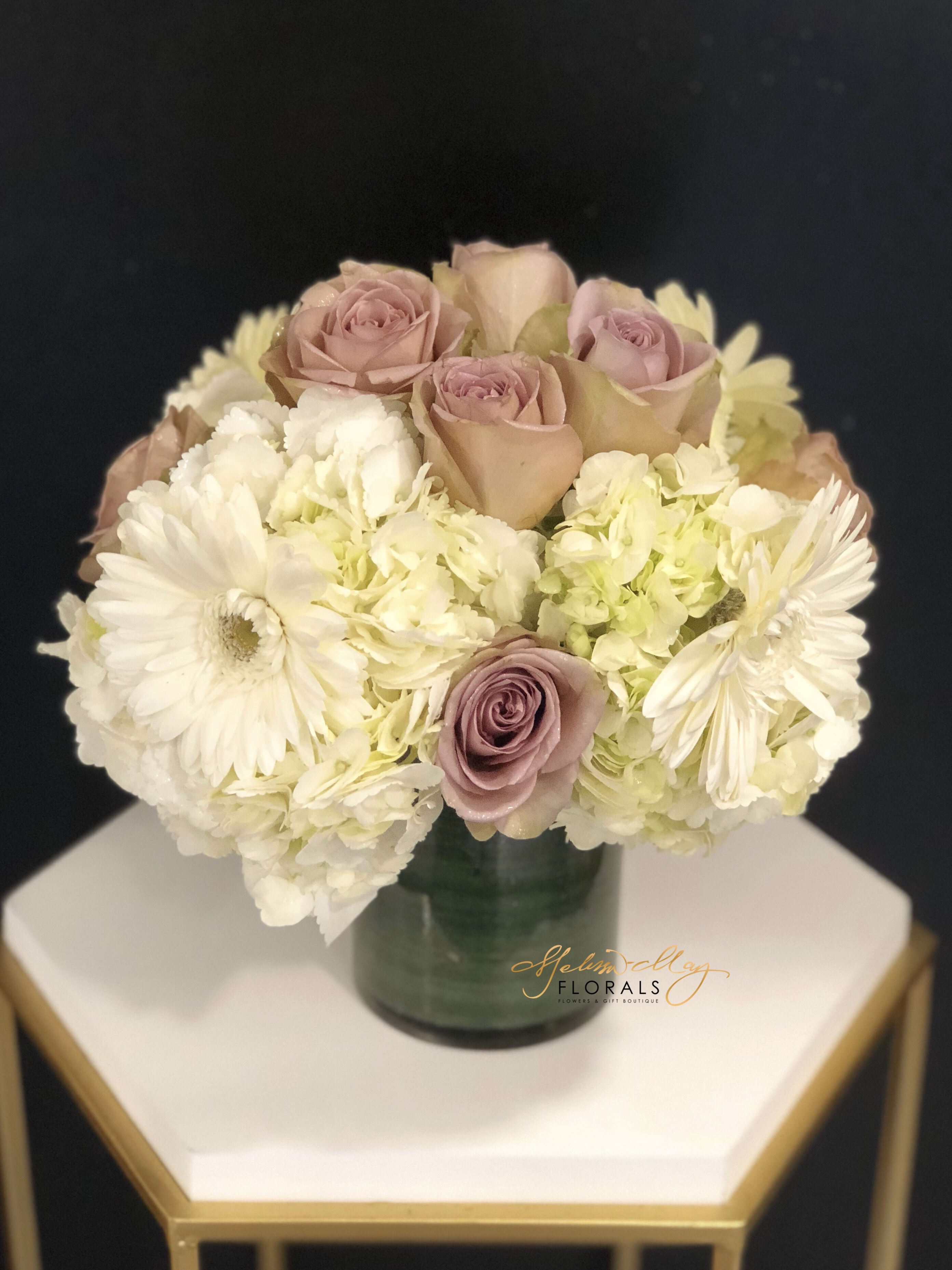 Sprinkle of Purple - A touch of purple to bring out a white arrangement. Sometimes you want an arrangement that is simple but will provide an elegance like no other. A sprinkle of purple will do just that there is white Hydrangeas and lavender roses. 
