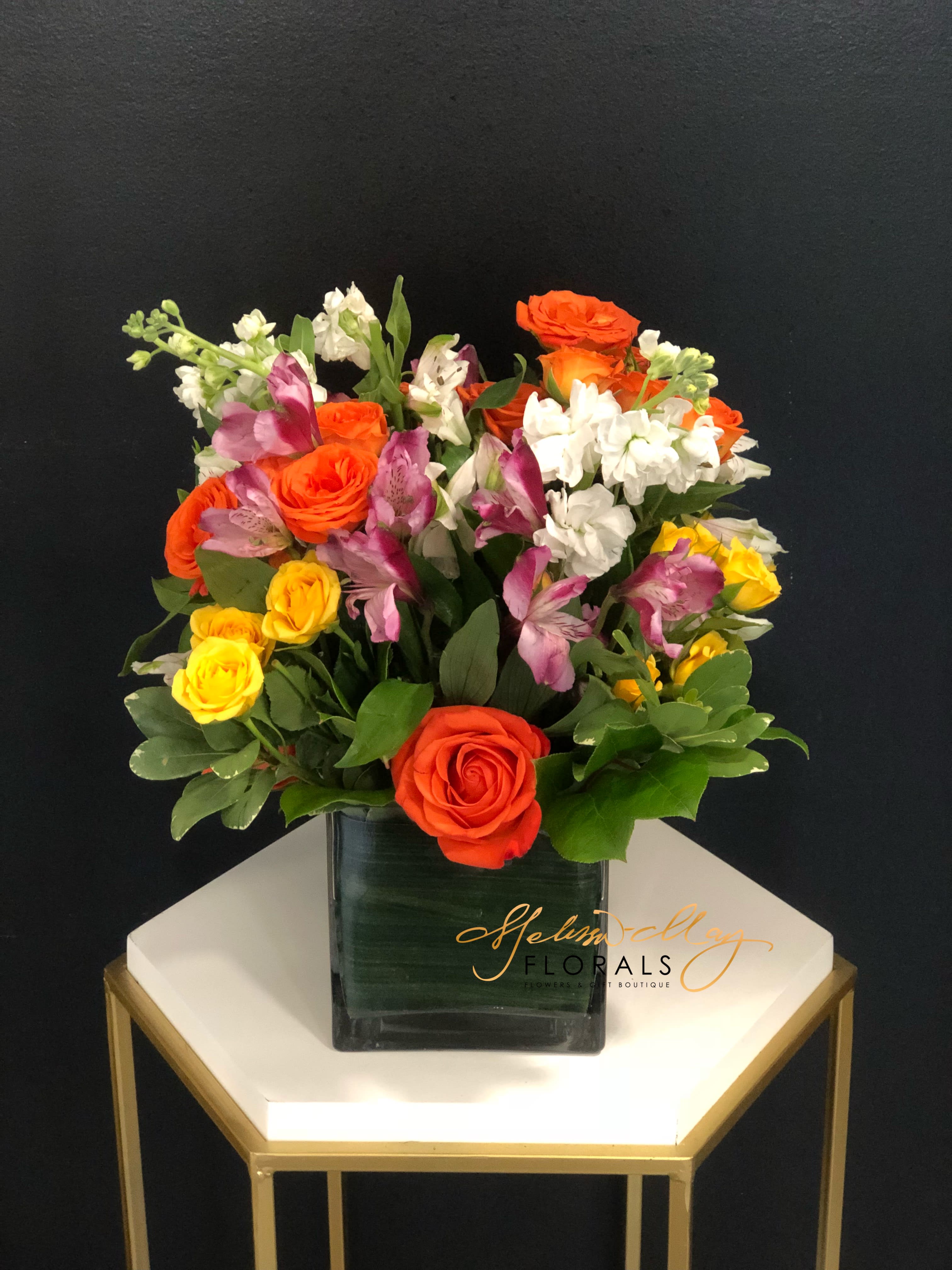Darling Delights - It is no surprise that arrangements speaks for us when we are unable to find the words. Tell that special person they are your darling everyday with this beauty. We bring you orange roses, yellow spray roses, white stock, purple alstroemerias, and so much more. 