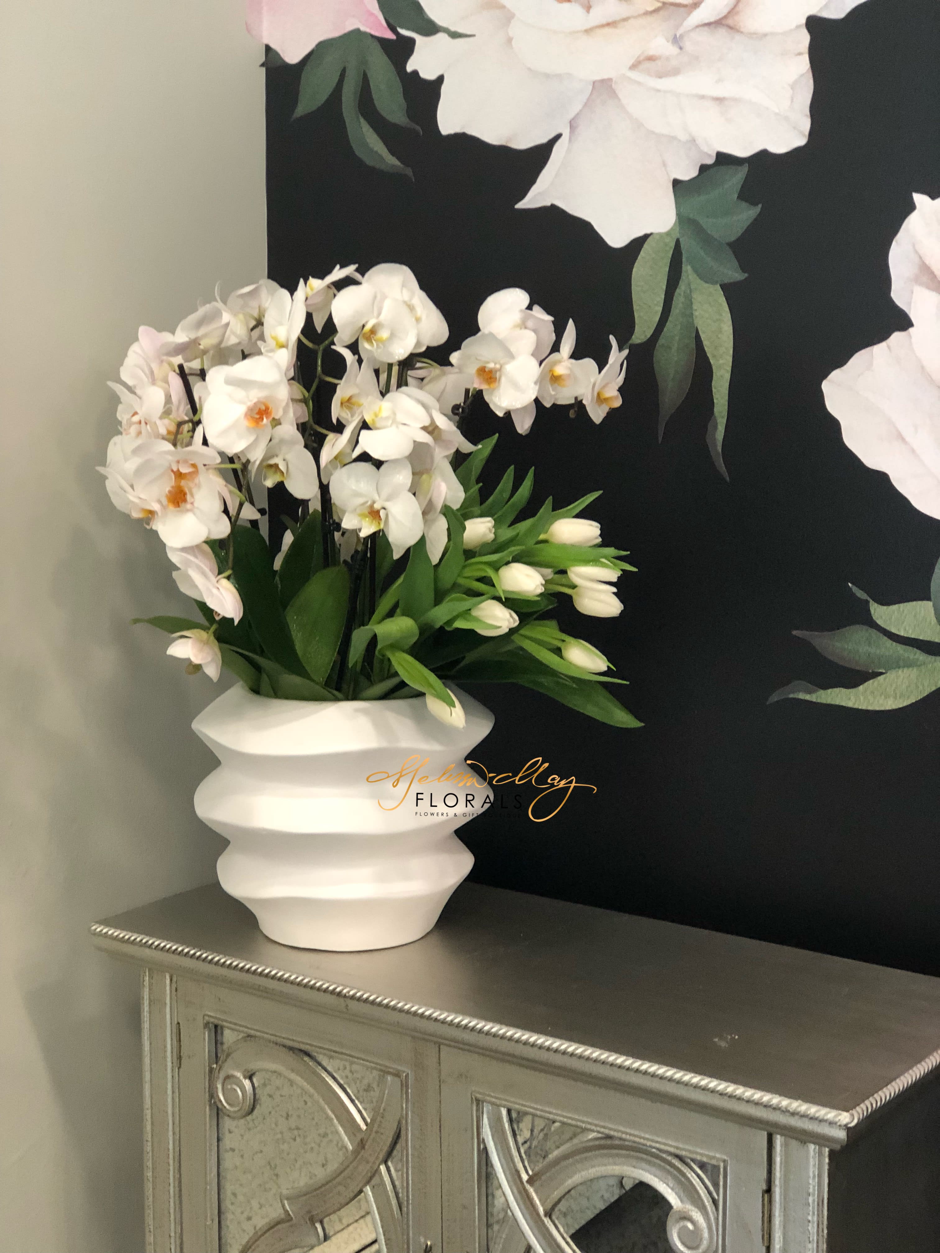 Everlasting Elegance - We bring elegance in our unique ceramic limited edition vase. Its filled with everlasting orchids and tulips. Bring this piece into your home and have it front row center so everyone can admire this beauty.(Vase in image is no longer available. A substitute will be used.)