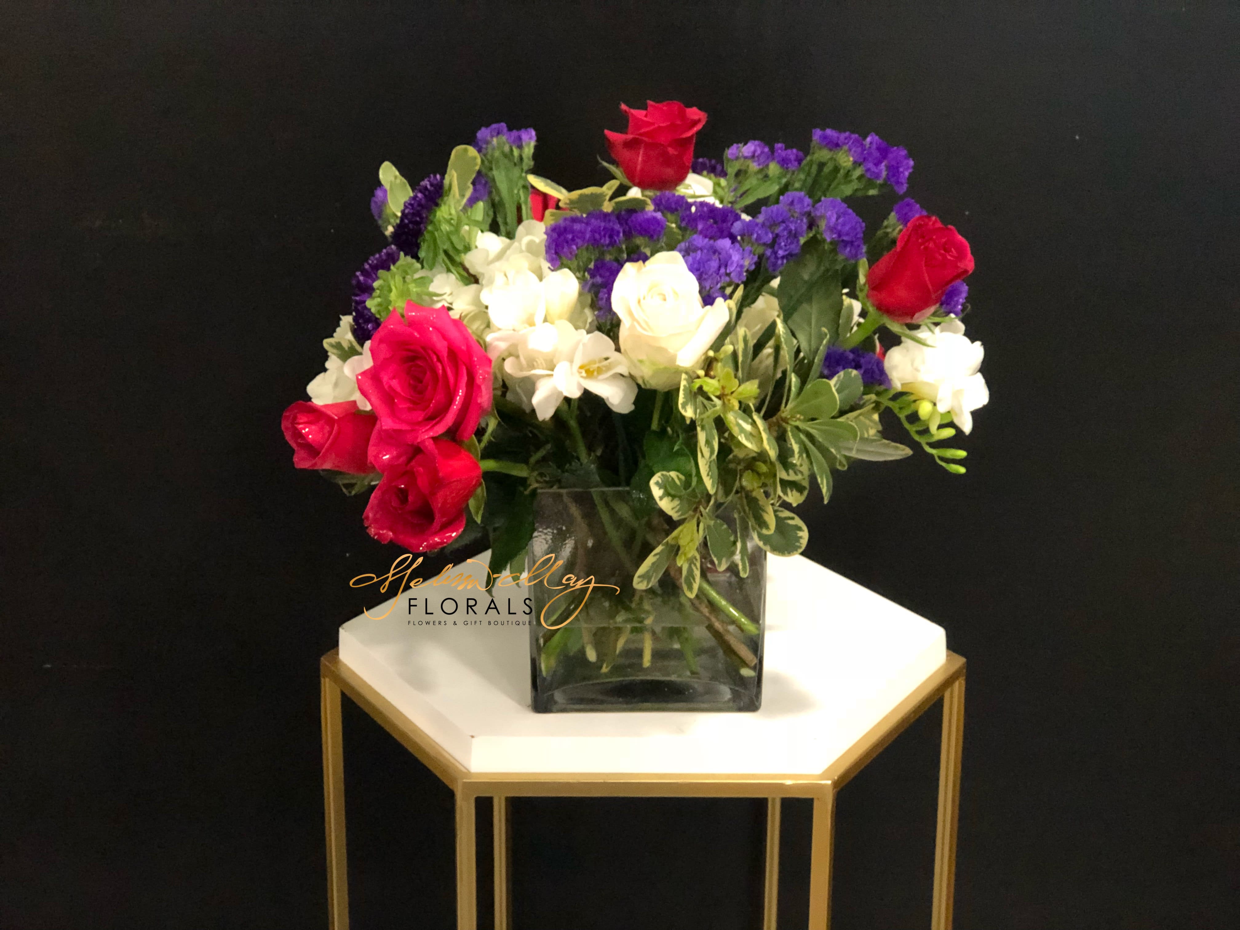 Best Friends Forever - Friends are not always the easiest to come around, but when you do find them it makes your life go by with a breeze. Who doesn't love red, purple, and white all together? We bring red  roses, white roses, statics, and lush greenery.  