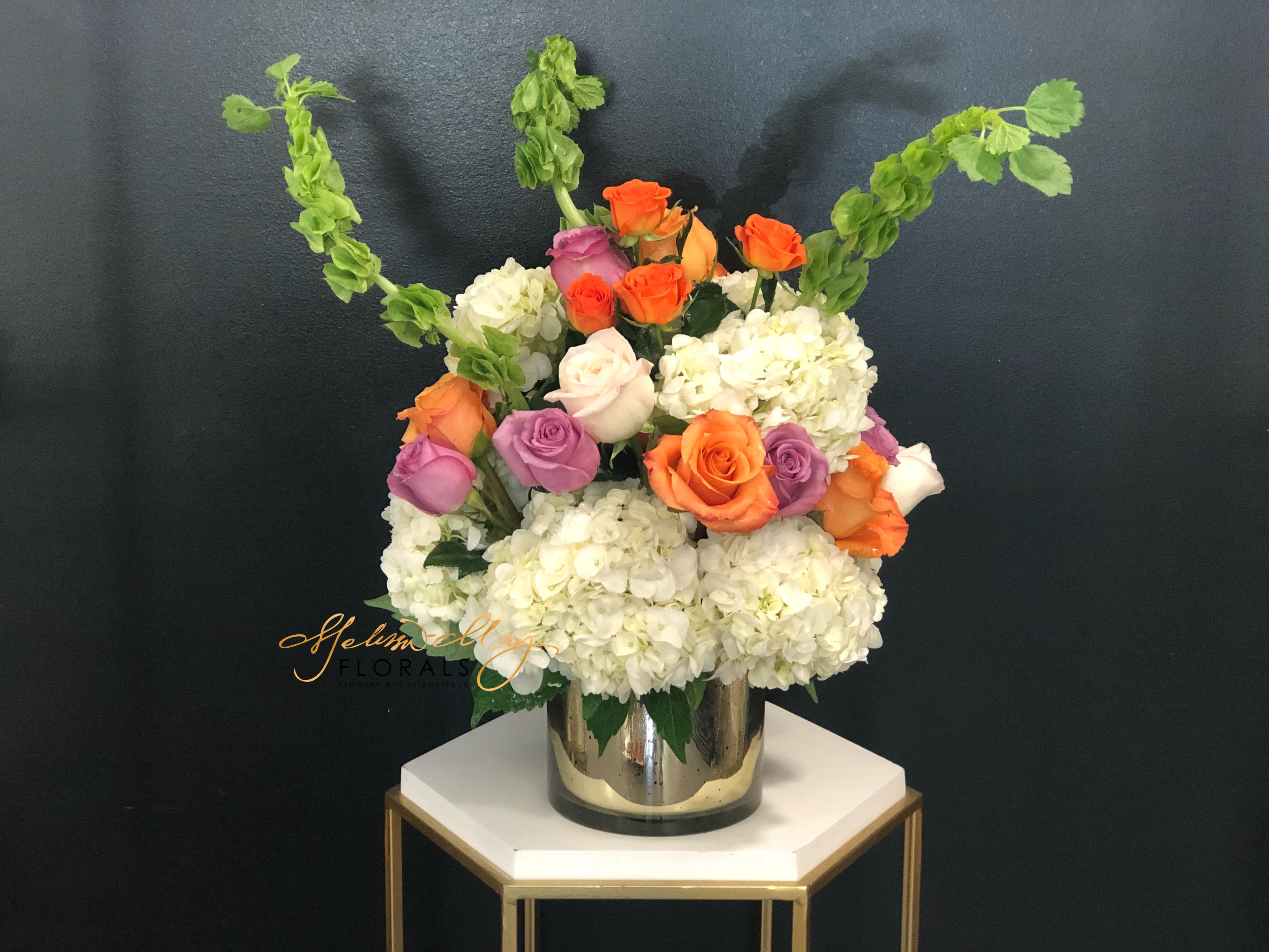 Brightness Morning  - No matter what occasion you are celebrating you will always find that this arrangement creates the perfect statement. A statement that will last a lifetime. You ever wanted to make someone morning feel like the brightest morning there is. Well gift them with this floral arrangement! Its filled with hydrangeas, orange/ lavender roses. 