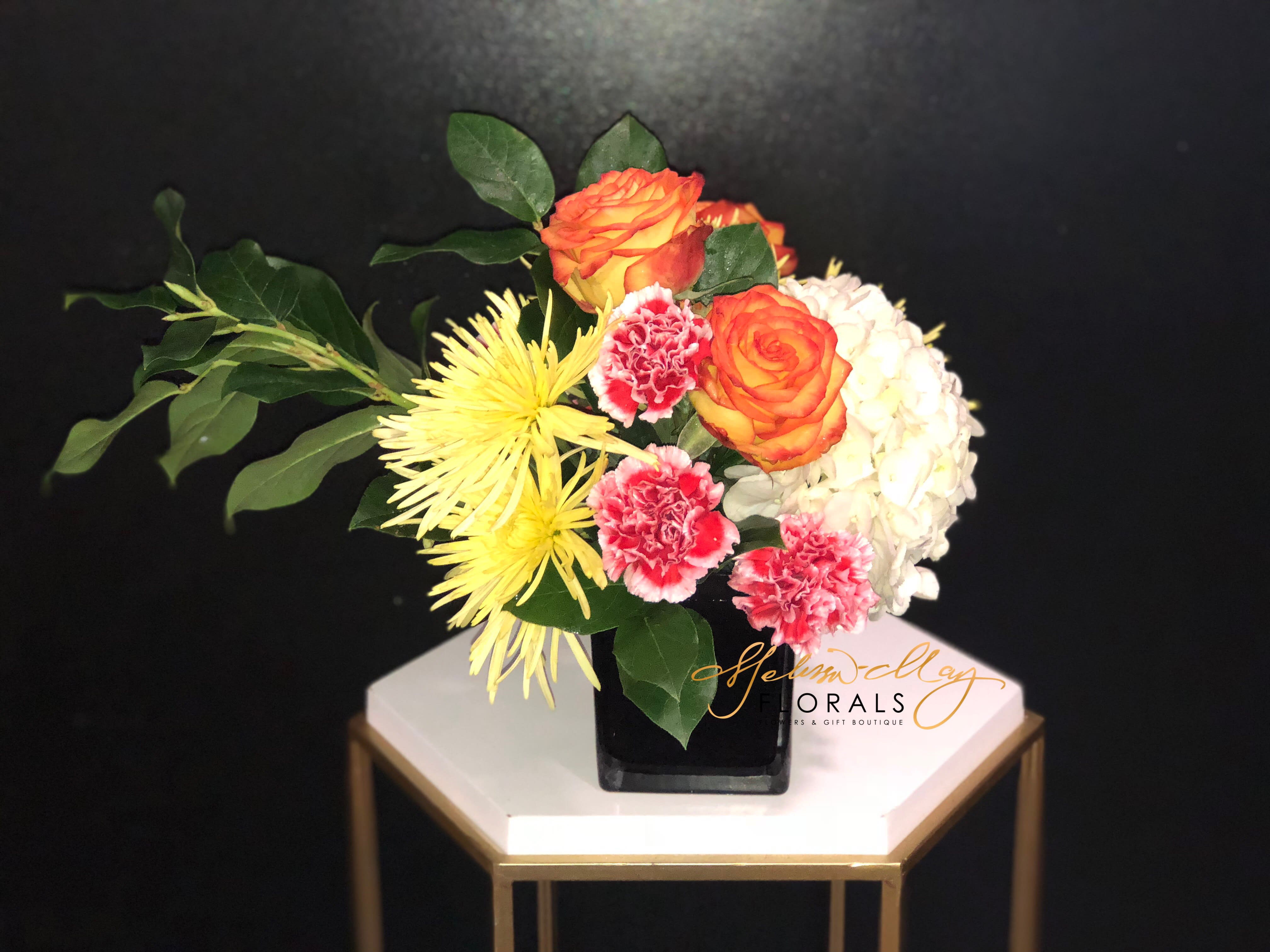 Gentle Arrangement - Arrangements are meant to be gentle so snatch this lovely piece. Its filled with roses, hydrangeas, and carnations. Its a soft arrangement that can you not go wrong with. 