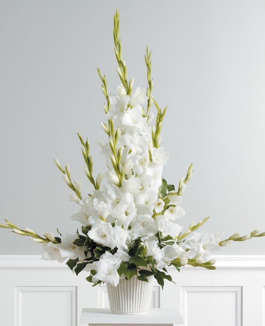 Gladiolus Essence Gladiolus Essence - Urn spray filled with the beauty of gladiolus. Color options may be available. A towering display of select White Gladiolus offer a memorable funeral service or home offering