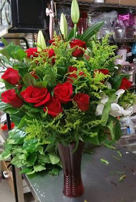 you and I By helms Flowers - 2 dz red roses with solidago and white oriental lilly in a romantic red vase 