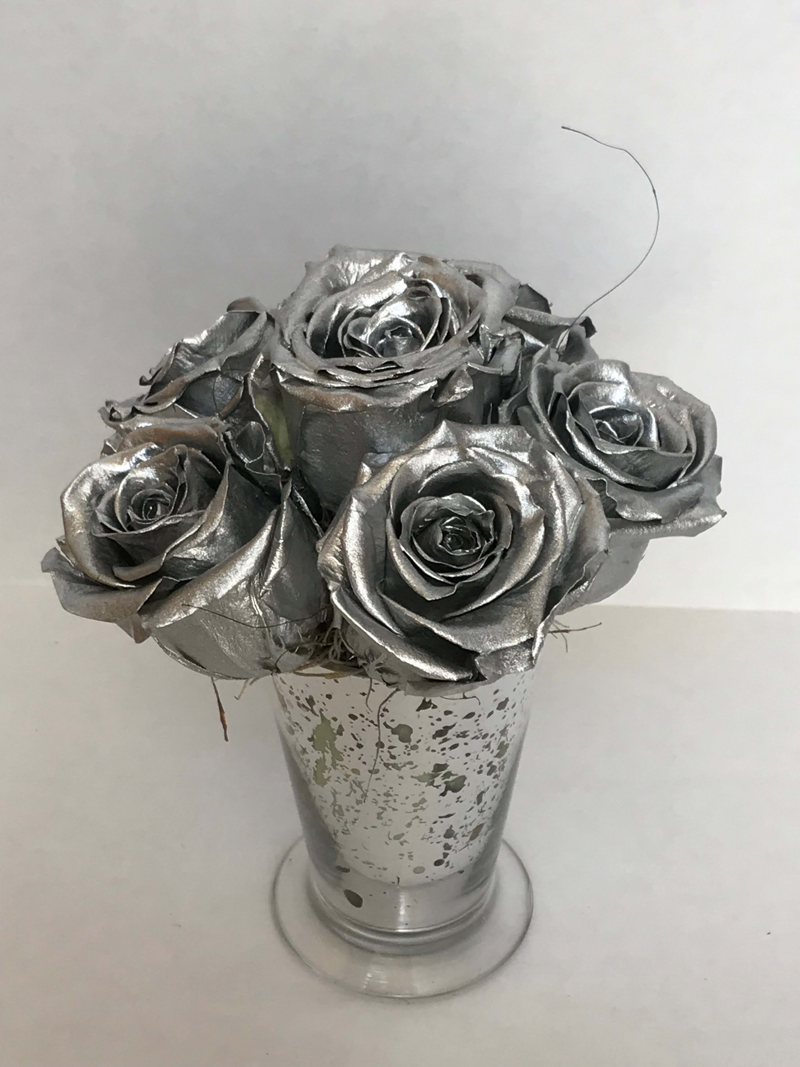Silver Royal - Royal collection  offers many preserved rose options.   Imagine the beauty and aroma of a fresh rose that is perfectly preserved. It requires no water. No sunlight. It simply rests in its beautiful crafted container to be admired for over 365 days. An immaculate gift that represents a pure, enduring and effortless love. Shop The Royal Roses collection. only at Helms Flowers Inc Dimentiosn Rose- 2.5 to 3.&quot; Vase (container) Small silver julep 4&quot; tall by 2&quot;