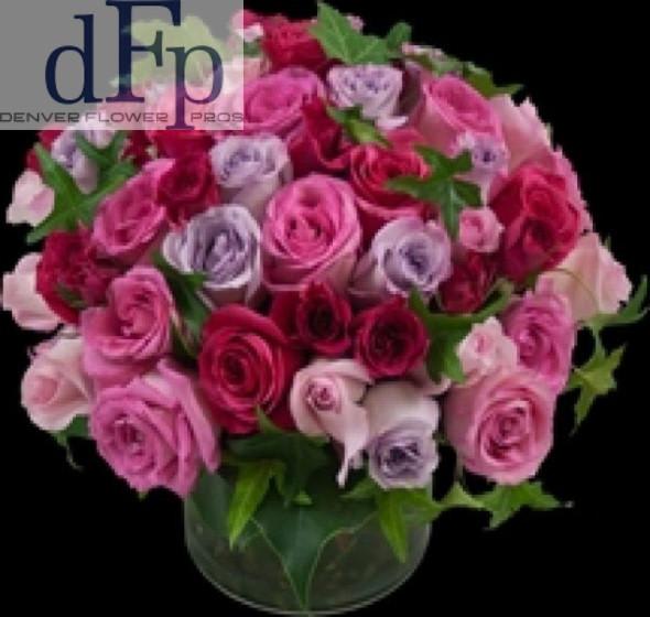 4 Dozen Lavender and Pink Rose arrangement 4 Dozen Lavender and Pink Rose arrangement - <p>In the French Pave style , a unique Rose arrangement with premium lavender and pink roses and fantastic greens arranged with seasonable greens and berries . Approximately 14-18 by 14-18 inches . Arranged in a Glass Cylinder.</p>