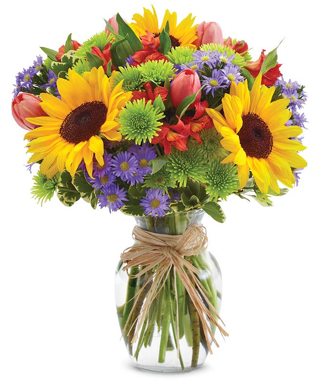  European Garden Bouquet - The essence of Europe comes to life in all its grandeur with this bright assortment of alstroemeria, button poms, Monte casino, sunflowers and tulips in an elegant clear glass vase.