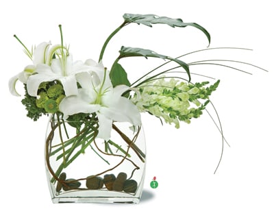 Feng Shui - A bold display of white blossoms such as oriental lilies and snapdragons, perfectly arranged in space, creates a stunning presentation when arranged in an angular vase with river rocks. This striking arrangement will add a touch of high style to any room.