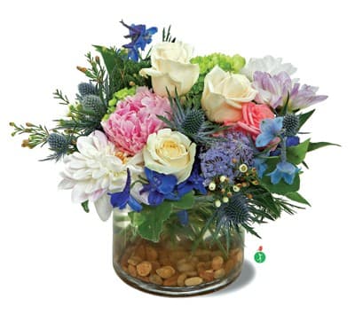 Breathtaking Blossoms Breathtaking Blossoms - You’d like to surprise someone with gorgeous fresh flowers…a mix of blooms that looks as if the entire garden has been put into a vase! This splendid medley of blue, cream, white, pink and lavender flowers, presented on a bed of river rocks, is a beautiful choice.
