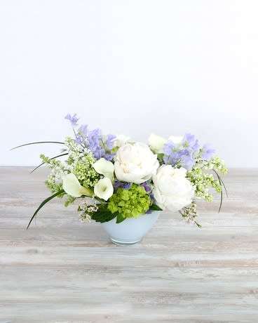 Lavender & Lace Lavender & Lace - Elegant, classic, and beautiful—just like her. This pretty presentation features lush white peonies, pristine calla lilies, and ivory lilac softly contrasted with lavender tones of wispy sweet pea and blooming hydrangea. Stems of gently curving lily grass and delicate waxflower add movement to an arrangement as lovely as she is.