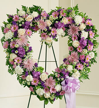Always Remember Lavender Floral Heart Tribute - Product ID: 91245   The passing of a beloved family member or friend is a sad and difficult time. You want to convey your deepest sympathies to those left behind while also remembering and celebrating a beautiful life. Expertly crafted with delicate lavender and white blooms, this lovely open-heart tribute is a beautiful expression of all the love you feel in your heart. Heart-shaped arrangement of lavender and white flowers such as roses, stock, carnations and more Comes on a wire easel with accents and satin ribbon Appropriate for family and friends to send directly to the funeral home Our florists use only the freshest flowers available, so colors and varieties may vary Measures approximately 30&quot;H x 30&quot;L without easel
