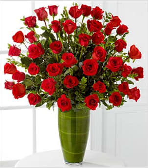 Fascinating Luxury Rose Bouquet - Fascinate and captivate your love. Nothing speaks from the heart more than our 24-inch premium long-stemmed rich red roses, situated in a superior 14-inch clear glass tapered bullet vase to create a classic display with a romantically sophisticated twist. A symbol of pure love and affection throughout the ages, this bouquet of our finest red roses will capture their heart. Includes: 40 stems of 24-inch premium long-stemmed red roses, assorted greens, exotic foliage and a superior 14-inch clear glass tapered bullet vase. Approx. 34H x 28W Your purchase includes a complimentary personalized gift message.