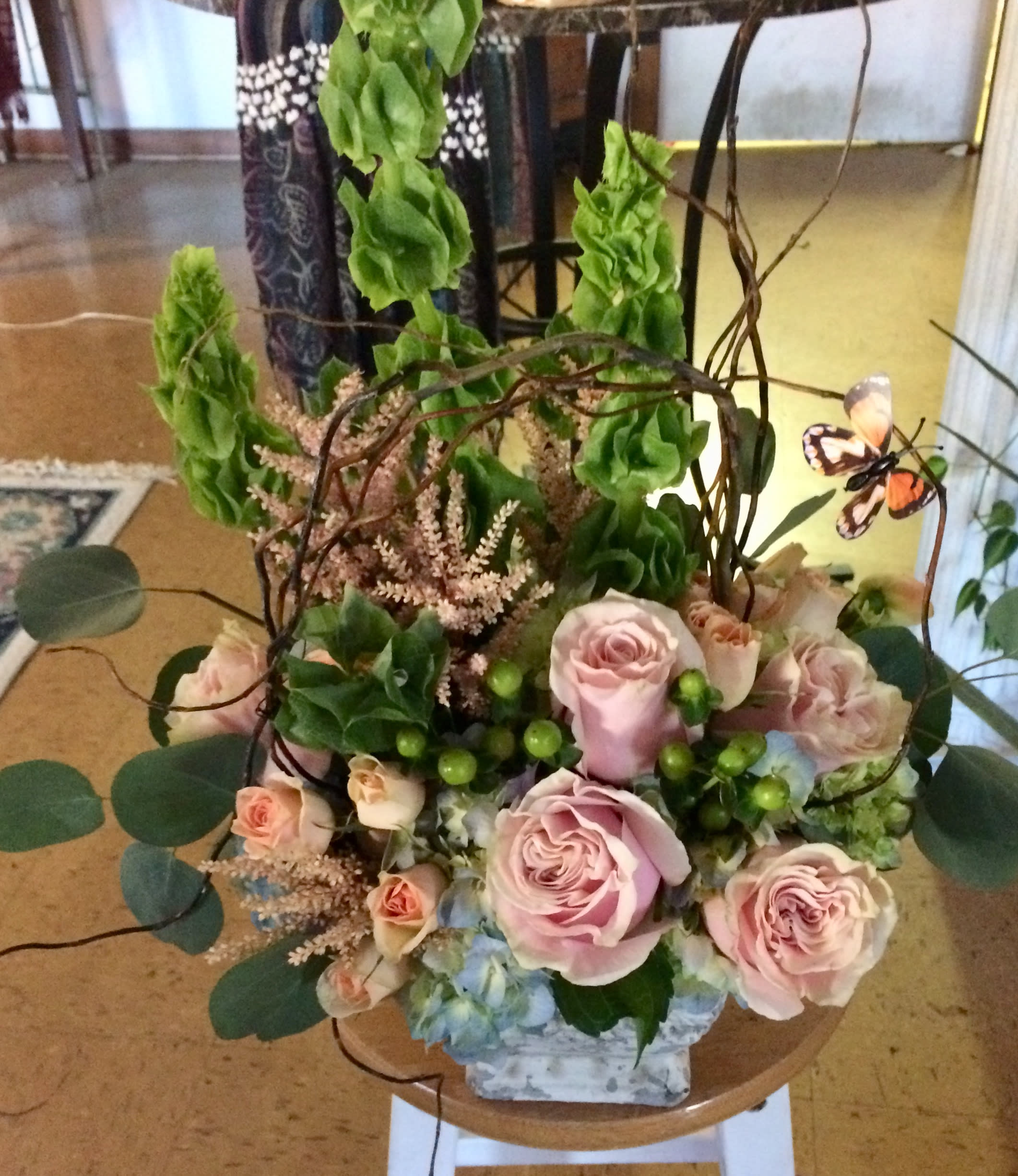 Love of Flowers - Bells of Ireland, roses, spray roses, hydrangea ad curly willow in a ceramic container. Great for any celebration or just thinking about you.