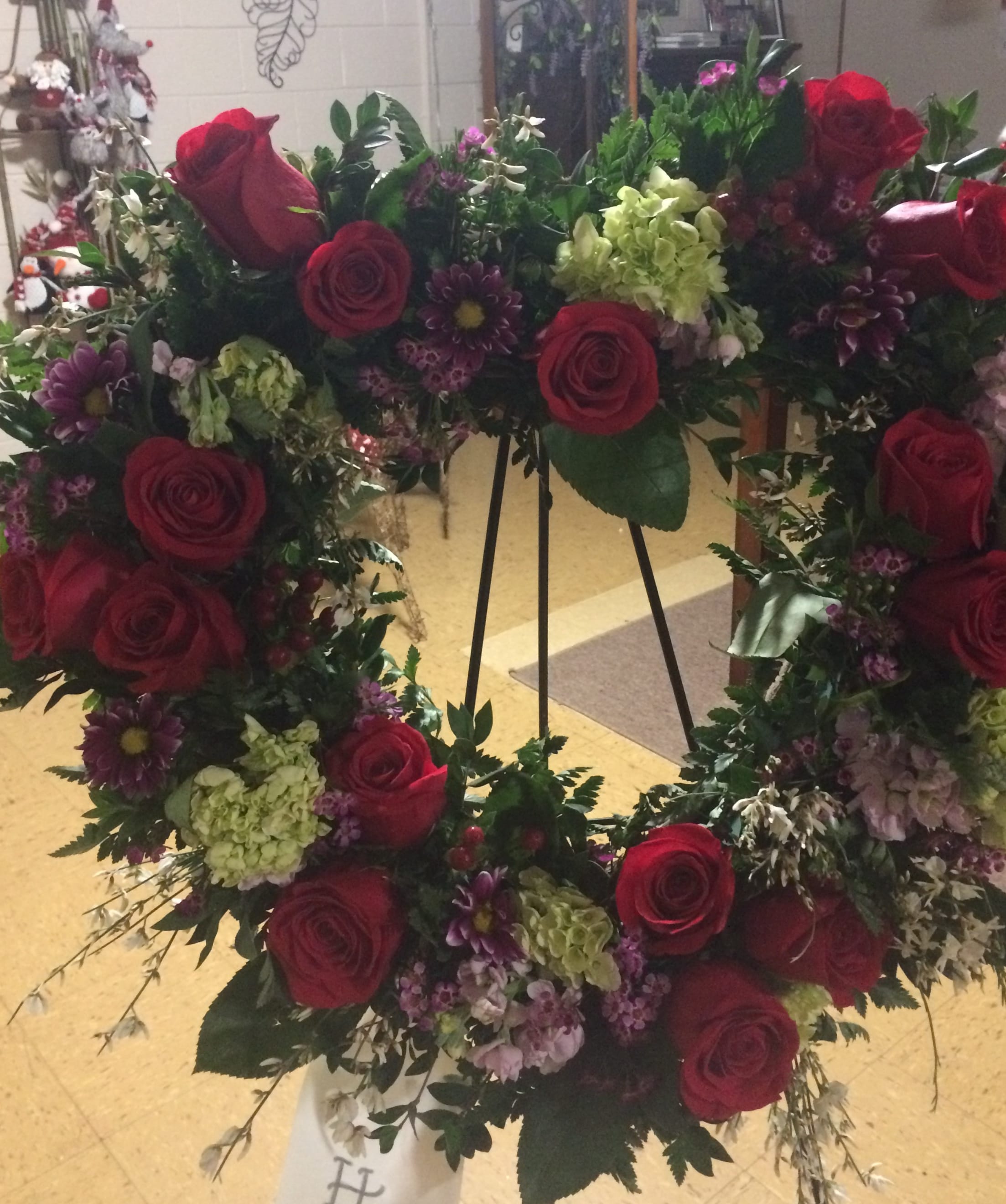 Open Heart - An open heart wreath with roses, hydrangeas, purple daisies and ginestra. For a funeral or memorial service