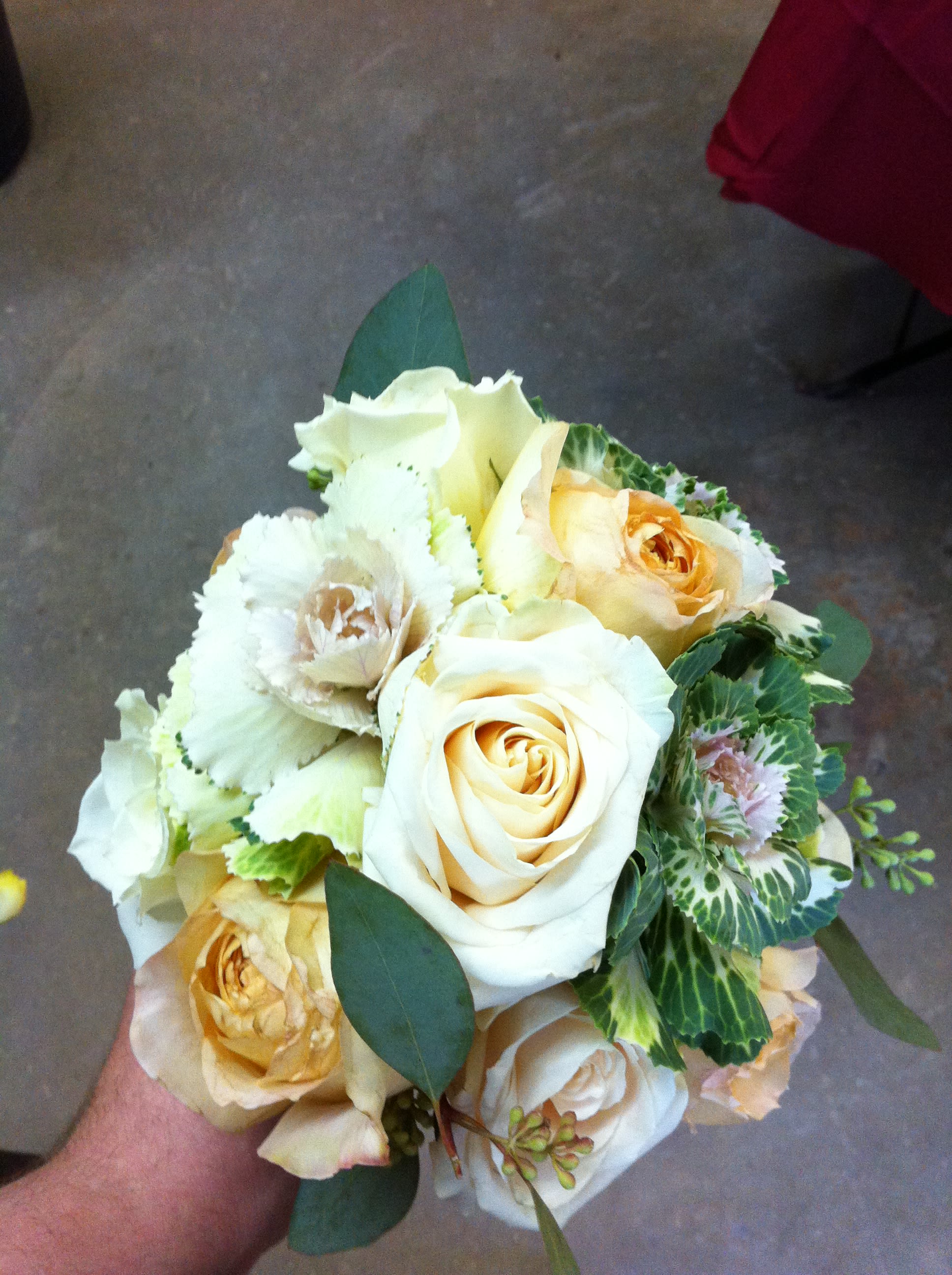 Cabbage Bouquet - For something a little different. This has flowering cabbage, cream, white, light orange garden roses with seeded eucalyptus. Then wrapped in cream double satin ribbon. We can change up anything colors, flowers, etc..
