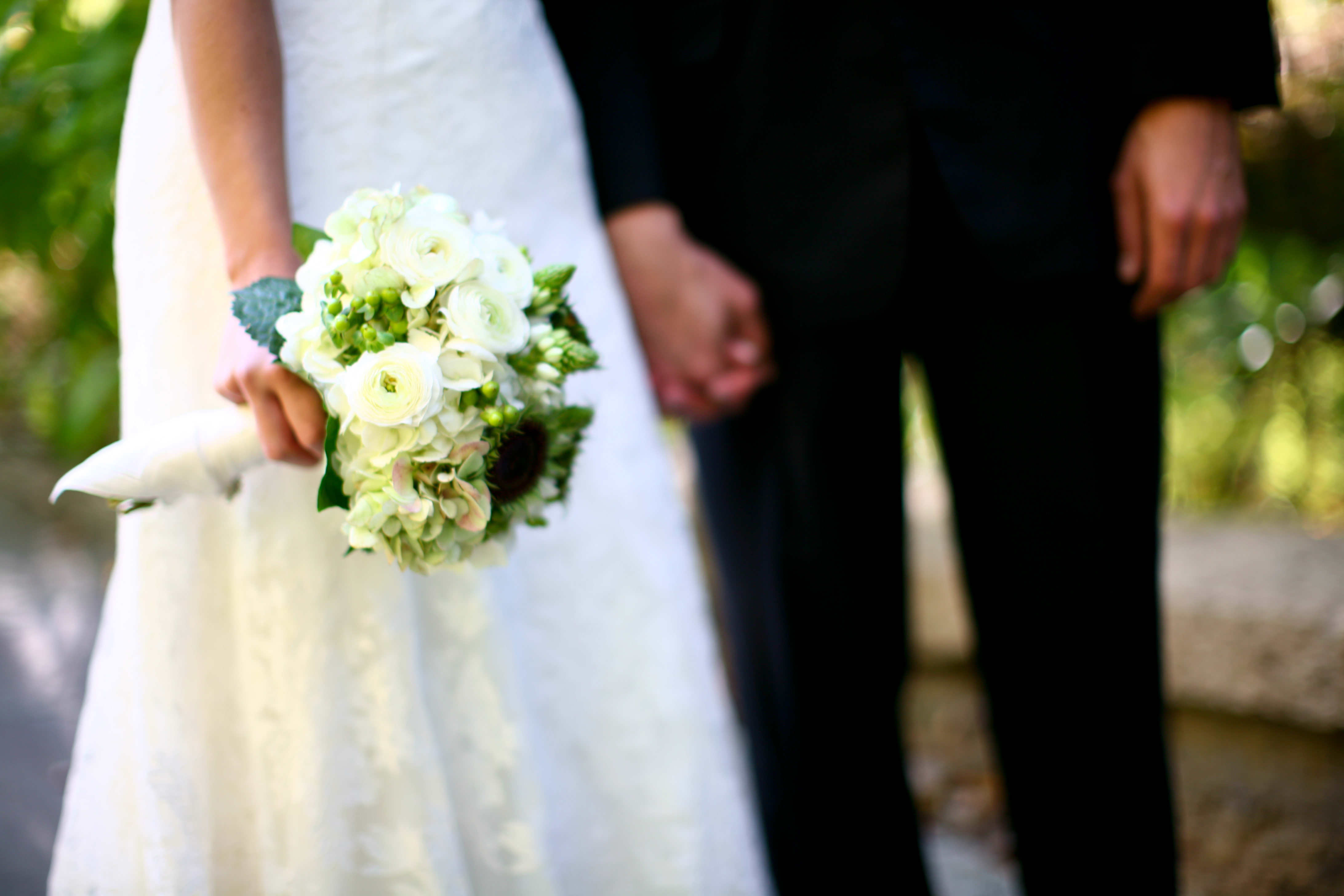 Lovely White Bouquet - This bouquet has a Antique Hydrangea, White, Ranunculus, Sunflowers that we pulled the yellow pedals, Hypericum Berry, Star of Bethlehem. Wrapped in a white double satin ribbon.