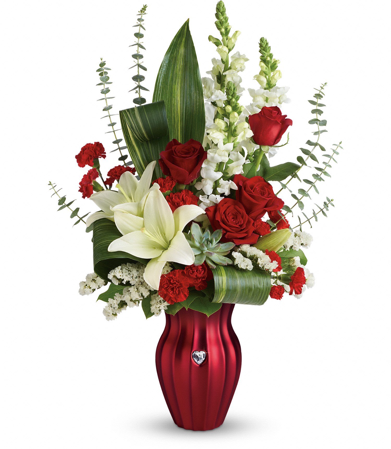 Teleflora's Hearts Aflutter Bouquet PM Teleflora's Hearts Aflutter Bouquet PM - A gift with heart! Make their heart flutter this Valentine's Day with a dramatic bouquet of radiant red roses, pure white lilies and snapdragons, lovingly hand-delivered in this elegant ceramic vase. Its luxurious satin texture and shimmering rhinestone heart make it a stylish keepsake they'll treasure forever!