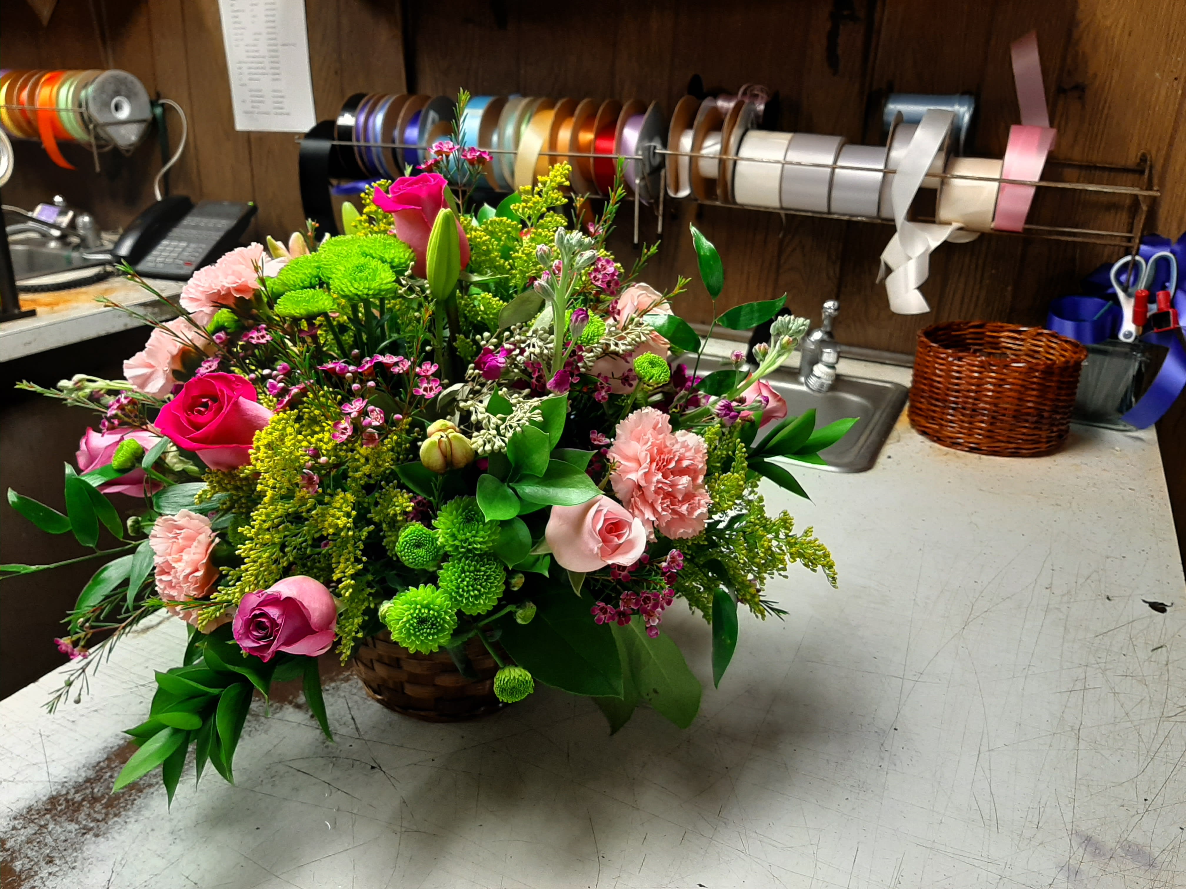 Roses, Lily, Carnations Roses, Lily, Carnations - Floral arrangement in a wicker basket