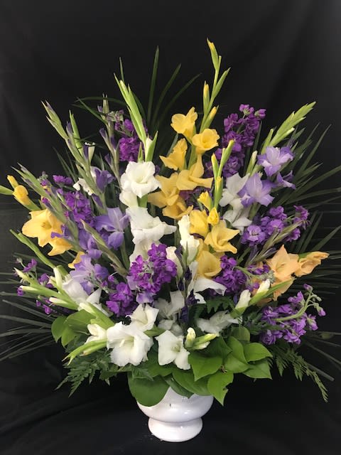 Endless Devotion Urn Basket - Beautiful yellow, purple and whites arranged in an urn basket a beautiful piece for sympathy. 