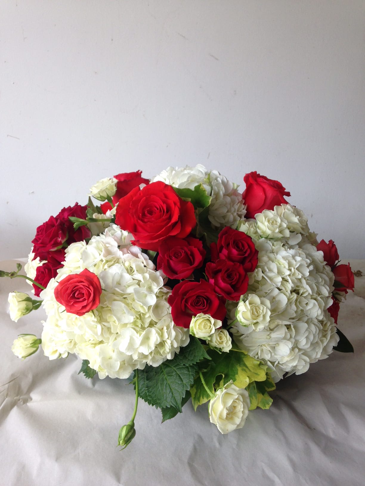 Say it lovingly with fabulous flowers - Fluffy white Hydrangeas with sweet red roses and touch of scented geranium