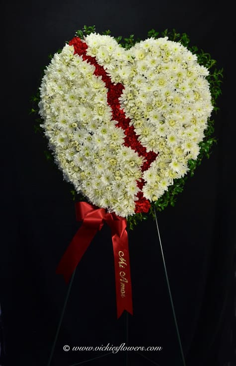 A Broken Heart A Broken Heart - A Broken Heart is a beautiful way to express the impact that the departed had on your life. Pearly white flowers form the shape of a heart, accented with greens "broken" in the middle with a line of rich red roses