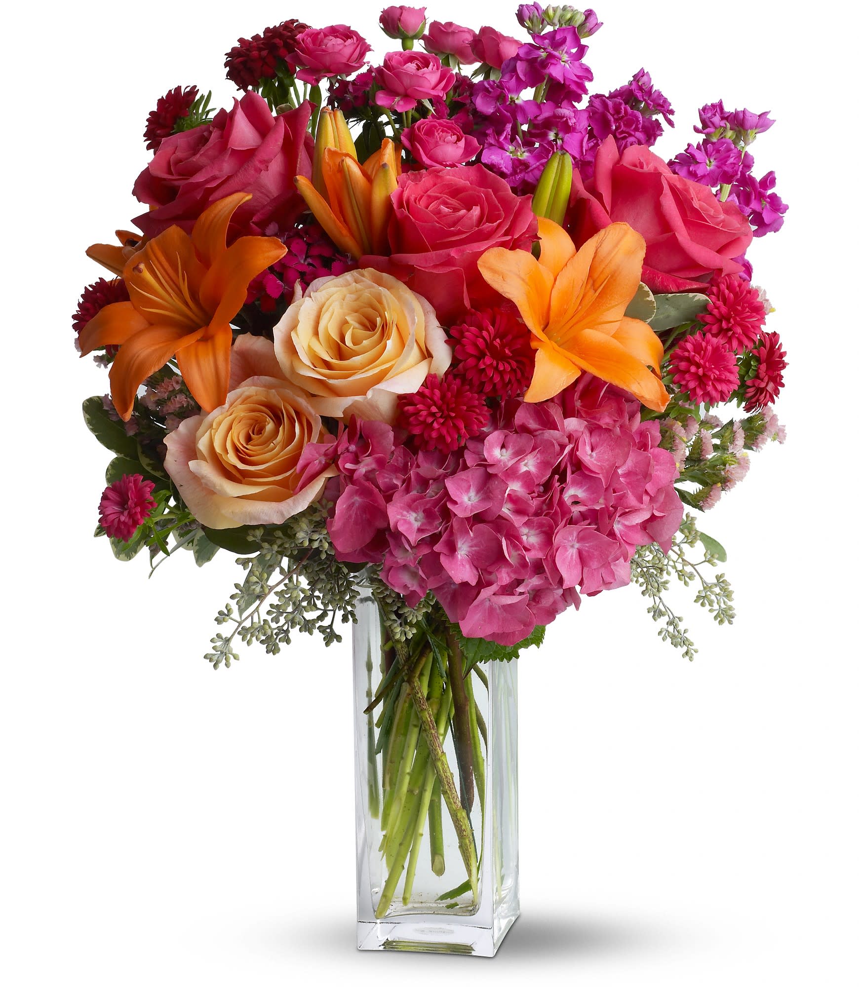 Joy Forever - Wow! That's what they'll say when this explosion of color arrives at the front door. They'll love the flowers, the clear glass vase - and you for having such exciting taste. A win-win for everybody!  The vibrant bouquet includes pink hydrangea, peach and hot pink roses, orange Asiatic lilies, purple stock, hot pink Matsumoto asters, peach statice, magenta Sweet William and hot pink spray roses accented with fresh greenery.  The flowers are delivered in a contemporary clear glass bunch vase.  Bouquet is approximately 15 1/2” W x 21” H  Orientation: All-Around      As Shown : TFWEB643  