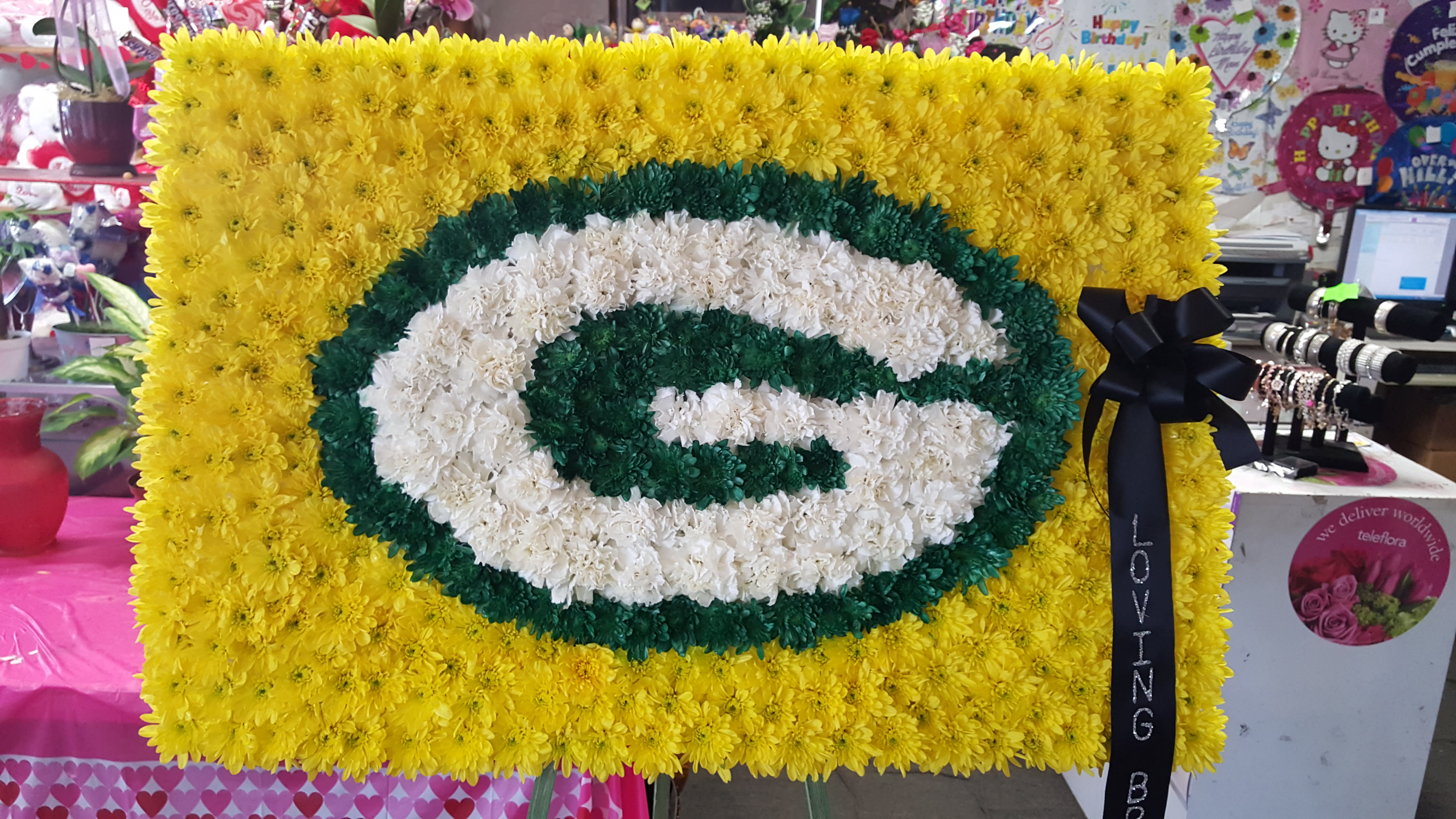 Green Bay Packers spray Green Bay Packers spray - 36" x 24" sports funeral spray using carnations, daisies and mums. ( Please call for specific sports team logo )