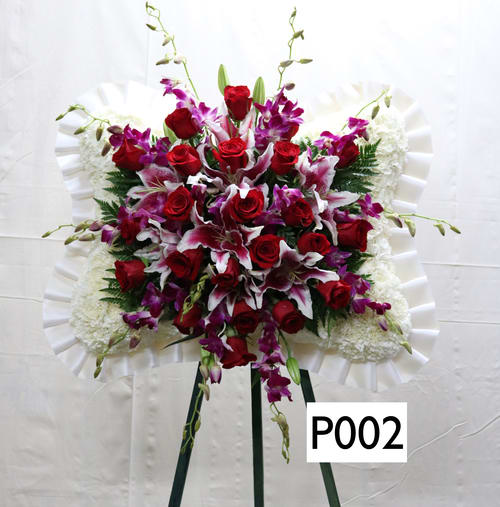 SP002 - Pillow shaped spray  --  Pink Lillies, Red roses, White Carnations, Purple Orchids