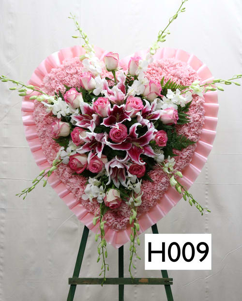 SP010 - Heart shaped spray  --  Pink Carnations, Pink Roses, White orchids, Pink Lillies