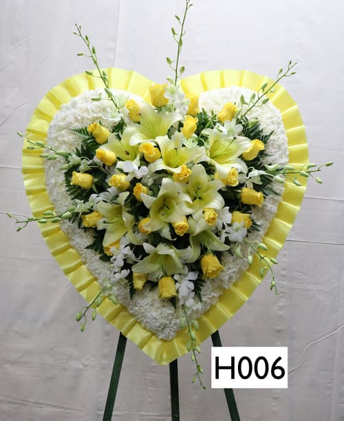 SP006 - Heart shaped spray  --  White Carnations, Yellow Roses, Yellow Lillies, White Orchids