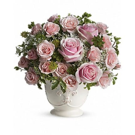 Parisian pink - As charming as a walk through the French countryside! Delicate Queen Anne's lace adds an air of antique lace to this Victorian arrangement. She'll love this beautiful bouquet of soft pink roses in Teleflora's French country pot.