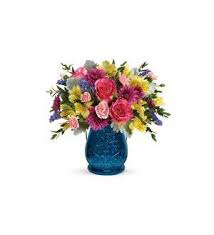 Burst of Blue - Below this bright, beautiful bouquet of pink roses and yellow alstroemeria is a cool burst of blue! This sapphire colored glass lantern, pressed with intricate details and adorned with a metal handle, is sure to be a favorite vase and candleholder.