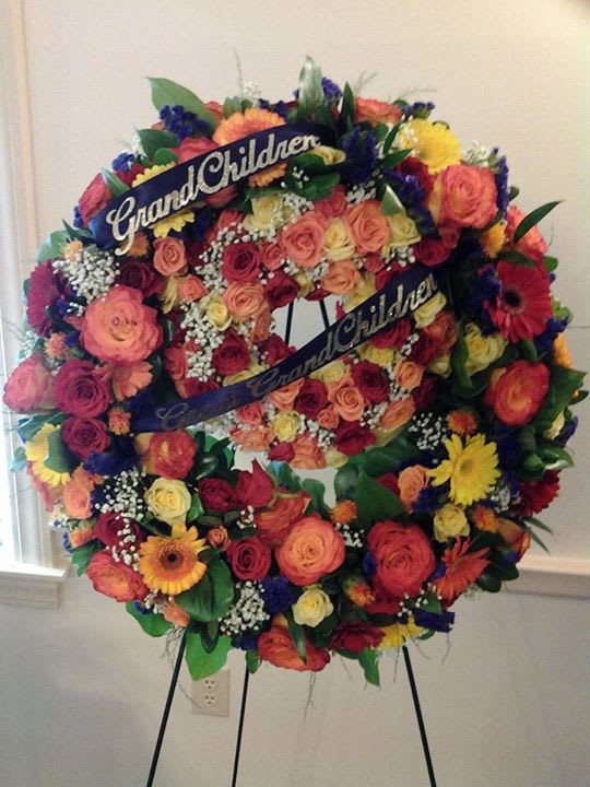  Standing Double Ring Memorial Wreathes - The Memorial Wreathes has regular sized roses, spray roses, gerbera daisies, status, a touch of Baby Breath with mixture of greens. Will change color of flowers, just let us know.
