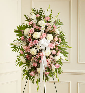 Deepest Sympathies Standing Spray-Pink &amp; White - Product ID: 91285   This Sympathy Standing Spray, in shades of peach, orange and white, is a beautiful symbol of your sympathy and support. Pink roses, stargazer lilies, spray roses, white carnations and more An appropriate gift for family, friends and business associates to send directly to the funeral home Our florists use only the freshest flowers available so colors and varieties may vary.