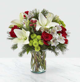 Christmas Spirit Bouquet - Whether you're sending season greeting's from across the country or welcoming guest to your home, our Christmas Spirit Bouquet shares every message of warmth and cheer. Filled with a collection of white lilies, red roses, red hypericum berries and white alstroemeria, this arrangement helps make every occasion beautiful. Give this to your loved ones, or as a gift to yourself to deck the halls during the holidays. 