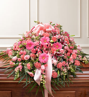 Cherished Memories Half Casket Cover - Pink -  Product ID: 91223   Send the perfect expression of your love and a tribute to a beautiful life. Features gorgeous long stem pink roses, stargazer lilies, Gerbera daisies, snapdragons, spray roses and more. Traditionally sent by the immediate family to the funeral home Our florists use only the freshest flowers available, so colors and varieties may vary Arrangement measures approximately 16âH x 28âW x 38âL
