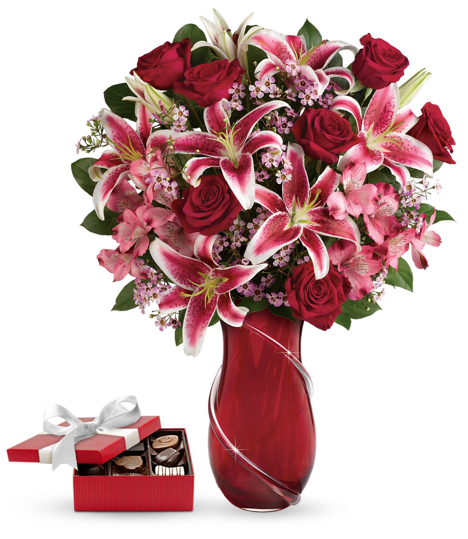 Wrapped With Passion Bouquet with chocolates PM - This luxurious gift set includes a delicious box of chocolates paired with a stunning bouquet. The ultimate in Valentine's Day luxury! Inspired by Italian art glass, this exquisitely crafted hand-blown glass vase is a keepsake she'll treasure forever. Its graceful shape and sparkling, hand-applied glass ribbon are the perfect complement to this dramatic bouquet of romantic long stemmed red roses and fragrant pink stargazer lilies delivered with a box of chocolates.