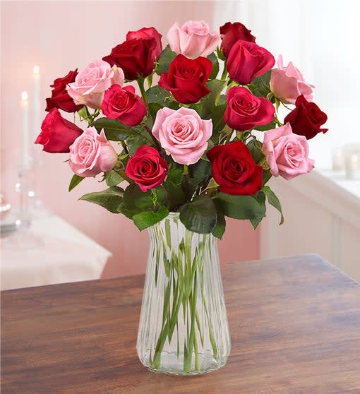 Enchanted Rose Medley Bouquet - There’s something so enchanting about our medley of Valentine’s roses. Classic red mixes with two shades of pink for a romantic surprise to lavish the one you love. Bouquet of red, light pink and hot pink roses; available in 18 or 36 stems Picked fresh on our premier farms around the world, our flowers are cared for every step of the way and shipped fresh to ensure lasting beauty and enjoyment Classic clear glass hourglass vase with elegant carved fluted detail; measures 9&quot;H (18 stems only)