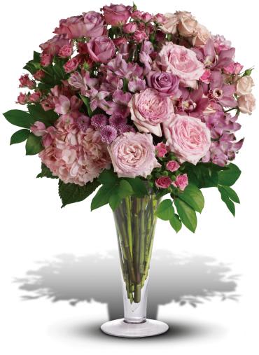 A La Mode Bouquet with Long Stemmed Roses -   Go all out for love with this breathtaking bouquet of pink orchids, pink roses, lavender roses and other fabulous favorites in a stylish flared glass vase. She will definitely be bowled over.  This exquisite bouquet includes pink orchids, pink hydrangea, pink roses, lavender roses, pink spray roses, light pink spray roses, pink alstroemeria and lavender button spray chrysanthemums accented with assorted greenery. 