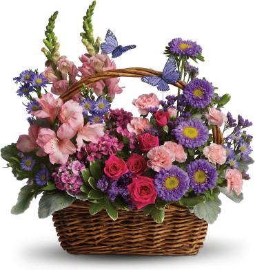 Country Basket Blooms -  Take a walk through a country meadow with this fresh flower basket! Pretty blooms of pink and purple nestle happily inside a natural gift basket as playful purple butterflies flutter overhead. 
