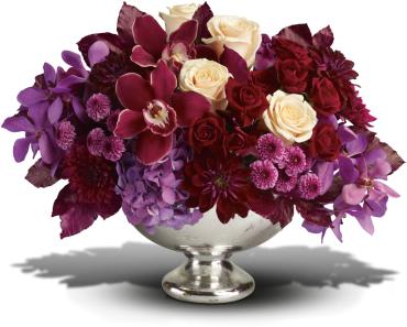 Lush and Lovely -   It's elegant, chic, even stunning. But your guests will simply describe it as &quot;Wow!&quot; This luxuriously lush, incredibly stylish arrangement gathers orchids, roses, hydrangea, dahlias and cushion mums into a gorgeous Mercury Glass Bowl. It's sure to make quite an impression as a fall or winter wedding centerpiece - or as a lavish gift delivered to someone truly special.  Lush blooms including lavender hydrangea, red cymbidium orchids, purple mokara orchids, crme roses, dark red roses, burgundy dahlias, lavender button mums and purple cushion mums are accented with burgundy copper beech leaves in generous Mercury Glass Bowl. 