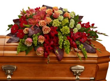 A Fond Farewell Casket Spray -  Bring majesty to the service with this gorgeous casket spray of orange roses and lilies and other brilliantly colored floral favorites. A touching tribute for someone special. 